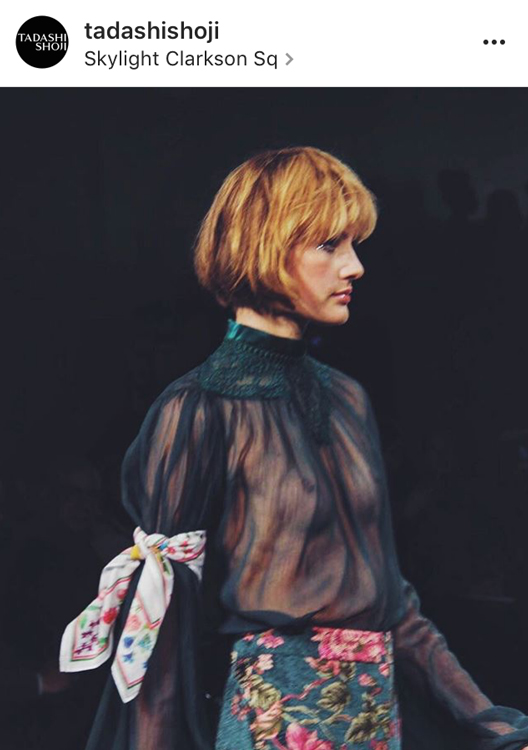 A model for Tadashi Shoji wears a white bandana during a show at New York Fashion Week 